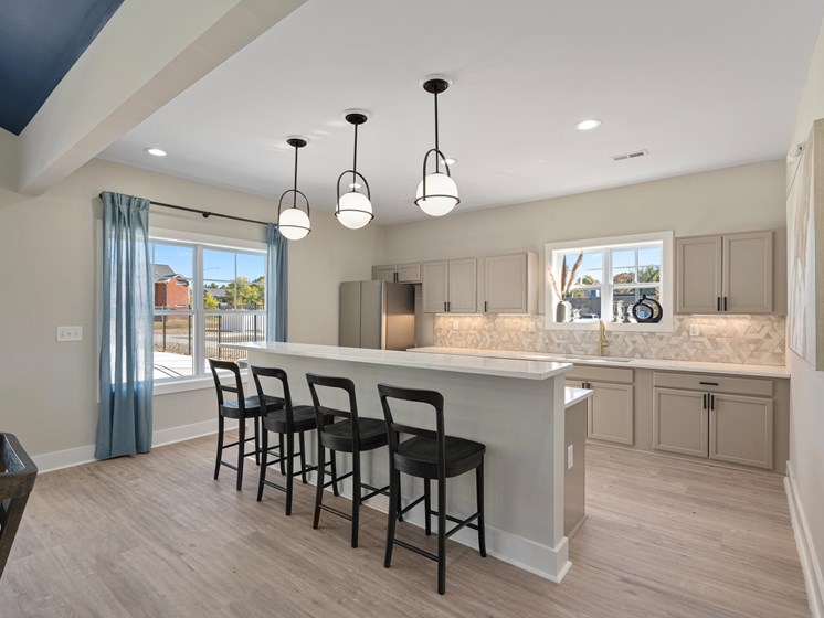 a kitchen with a large island with bar stools
